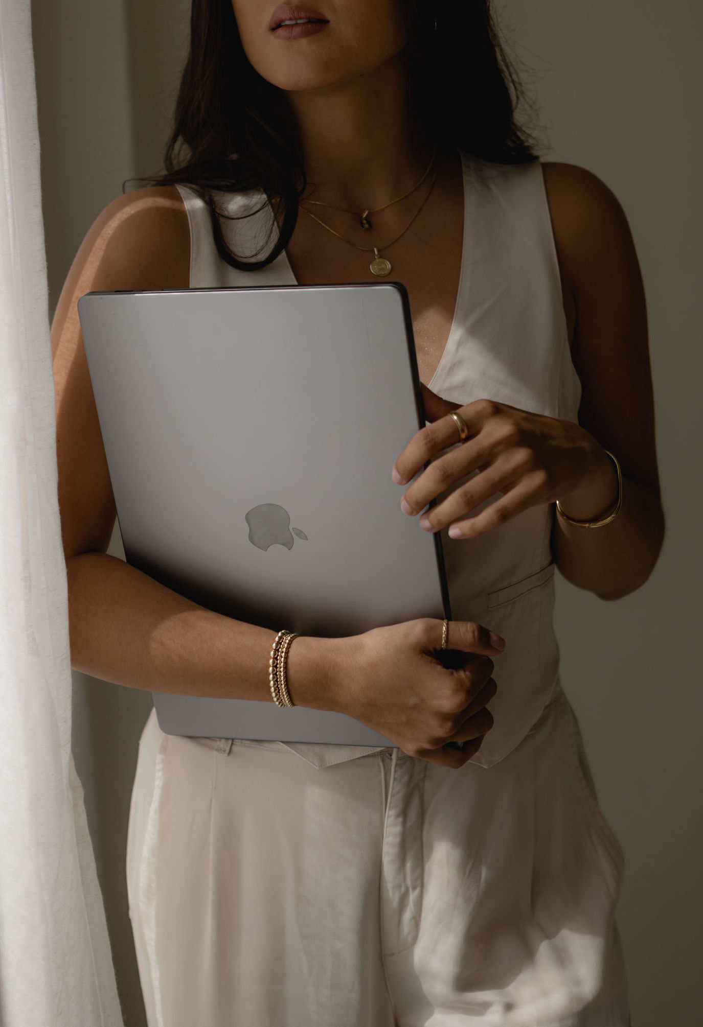 A professional woman holding a laptop, ready to navigate the complexities of paid and organic traffic strategies in the digital marketing realm.