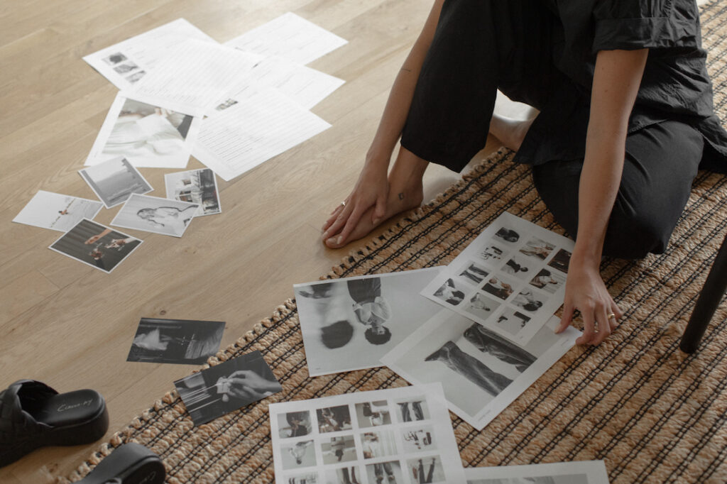 Person sitting on a carpet With a printed moodboard in front of her
